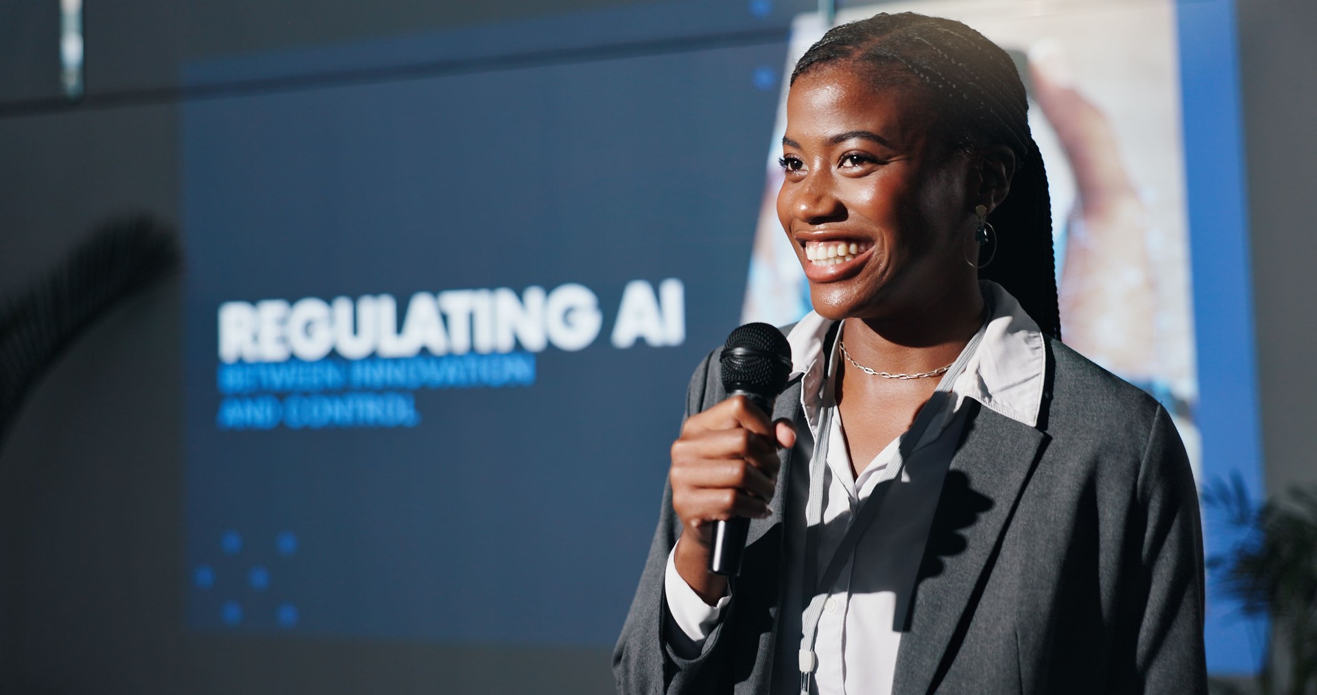 Black woman, presentation and screen at AI convention, info and regulation policy for accountability. Person, speaker and mic with talk for ethics, innovation and futuristic tech at global conference
