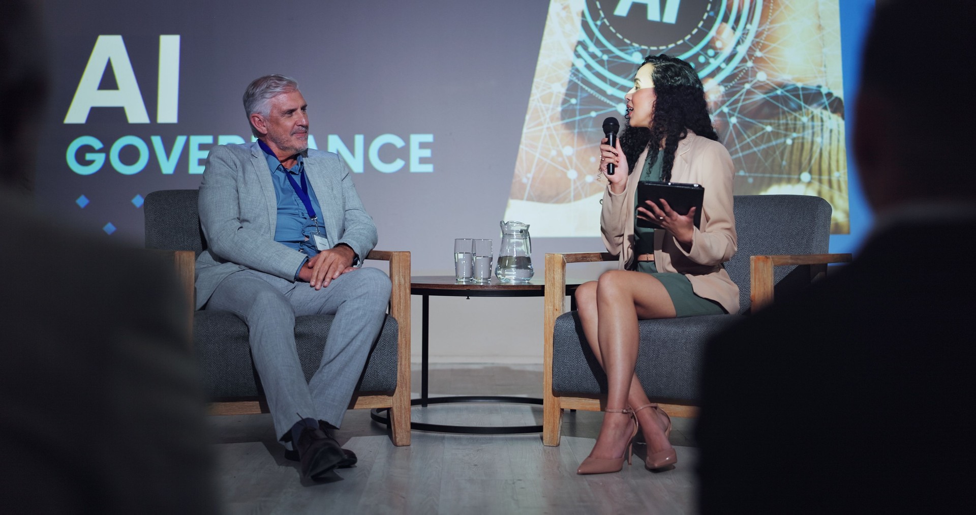 Ai, ethics and interview with business people at seminar for networking, industry panel and keynote speaker. Summit, conference and technology with speech for audience, event showcase and news