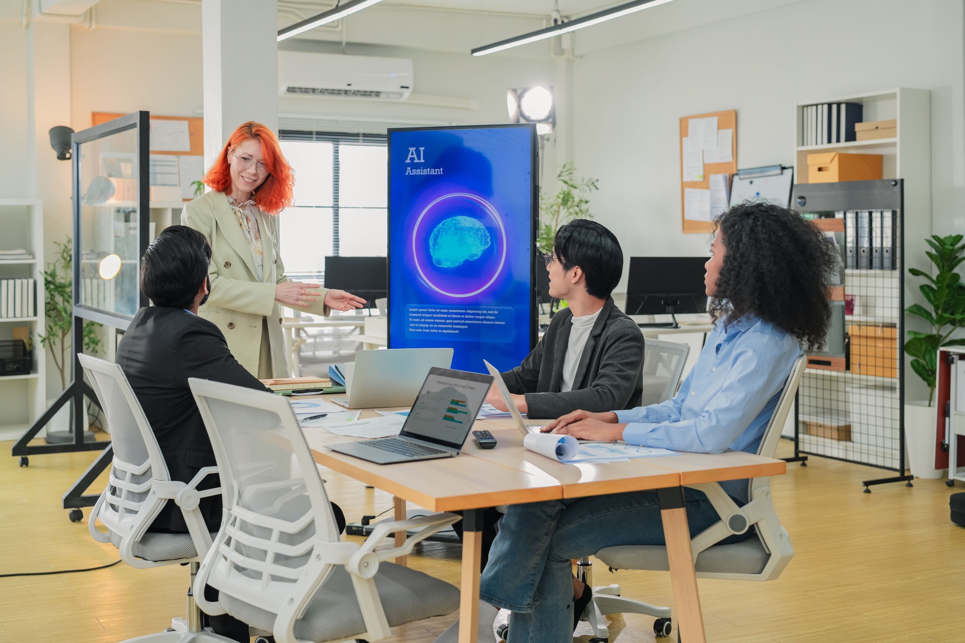 Diverse business professionals male and female meet in bright office interior, using AI virtual assistant to brainstorm, connect big data dots, discuss creative strategy teamwork growth and progress